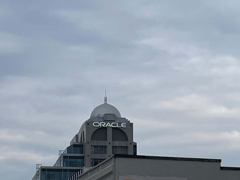 The top of office building at 55 King St W, its dome silhouetted against a cloudy sky.