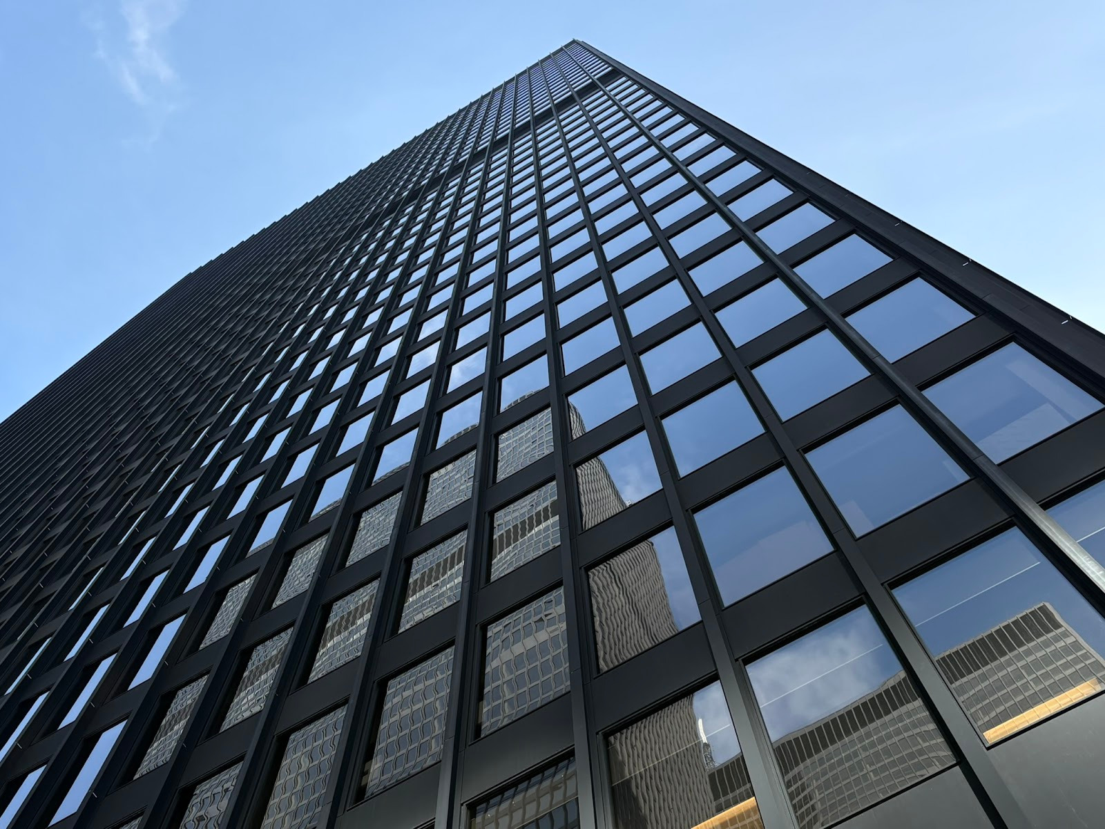 Photo of the black modernist TD skyscraper in Toronto, from the perspective of the ground looking straight up
